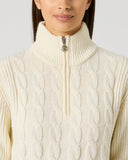 Daily Sports Ivory Cable Pullover Unlined close-up of cream ivory cable-knit pattern with quarter-zip stand collar and silver logo zipper pull detail