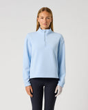 Women's light blue relaxed fit mid-layer golf top with half zip and stand-up collar – front view
