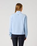Women's light blue relaxed fit mid-layer golf top with ribbed cuffs and Daily Sports logo tab – back view
