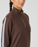 Close-up side view of women's brown half zip golf top with blue and white contrast stripe sleeve trim and stand-up collar
