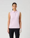 Daily Sports Woven Black Skort in black – women's A-line woven golf skort with structured waistband, silver double-button closure and side zip pocket, full length front view on model styled with white 3/4 sleeve polo, white visor and golf glove