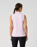 Daily Sports Woven Black Skort in black – women's A-line woven golf skort showing back kick pleat, structured waistband and clean tailored fit, three-quarter back view on model styled with white 3/4 sleeve polo and white viso