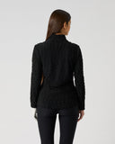Women's black textured wave pattern long sleeve golf top with fitted silhouette and stand-up collar – back view
