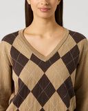 Close-up of women's camel and brown argyle knit V-neck golf pullover with diamond pattern and contrast stitch detail
