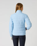 A woman viewed from the back wearing a light blue quilted puffer jacket and dark navy leggings, standing against a plain light gray studio background.