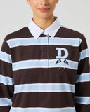 Close-up of women's brown stripe rugby polo with embroidered Daily Sports "D" logo, crossed golf clubs, and button placket
