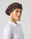Daily Sports Hudson Brownie Beret in dark chocolate brown – women's ribbed knit golf beret with metallic logo pin, side view styled with white golf polo