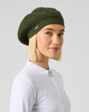 Daily Sports Hudson Khakora Beret in Dark Green Olive – women's ribbed knit golf beret with metallic logo pin, side view styled with white golf shirt