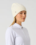 Daily Sports Ivory Cable Knit Hat in cream ivory – women's chunky cable-knit golf beanie with ribbed cuff and silver logo pin, side view