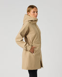 A woman wearing a mid-length beige hooded coat with a waist tie, shown in profile against a light gray studio background.