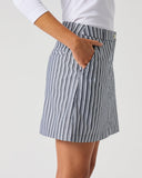 Daily Sports Stripe Dark Navy Skort close-up of dark navy and white vertical pinstripe fabric with tailored elasticated waistband and angled side pocket detail, side view
