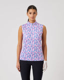 Woman wearing a sleeveless patterned top on a plain background