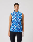 Woman wearing a blue patterned sleeveless top on a gray background