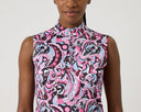 Woman wearing a sleeveless patterned top with pink, black, and blue design on a white background