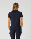 Daily Sports Dark Navy Piping Short Sleeve Polo in deep navy – women's short sleeve golf polo showing white contrast piping along shoulder seams and clean tailored back panel, back view on model styled with navy trousers and golf glove