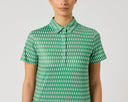 A model wearing a short-sleeve collared button-up shirt with a green and white repeating chevron pattern, shown against a plain light gray background.