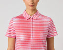 A model wearing a short-sleeve collared polo shirt with a red and white gingham pattern, shown from the nose down against a light gray studio background.