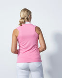 Person wearing a pink sleeveless top and white pants on a light gray background