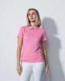 Woman wearing a pink polo shirt against a white background