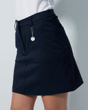 Black skirt worn by a person on a plain background