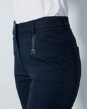 Navy pants with a belt and zipper on a light gray background