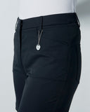 Black pants with a chain detail on a gray background