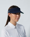 Woman wearing a navy visor against a white background