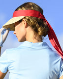 Woman wearing a red visor and light blue shirt against a clear sky