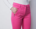 Person wearing bright pink pants with a white background