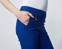 Person wearing blue pants with a white background