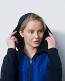 Person wearing a blue puffer jacket with a hood against a white background