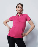 Woman wearing a pink polo shirt against a white background