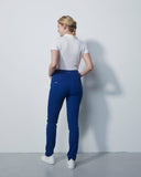 Person wearing a white shirt and blue pants against a plain white background