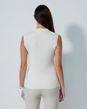 Woman wearing a white sleeveless ribbed knit top against a plain background