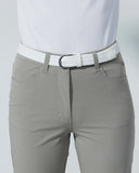 Beige pants with a white shirt and white belt on a light gray background