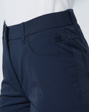Navy blue pants with a belt on a light gray background