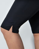 Black shorts worn by a person on a light gray background